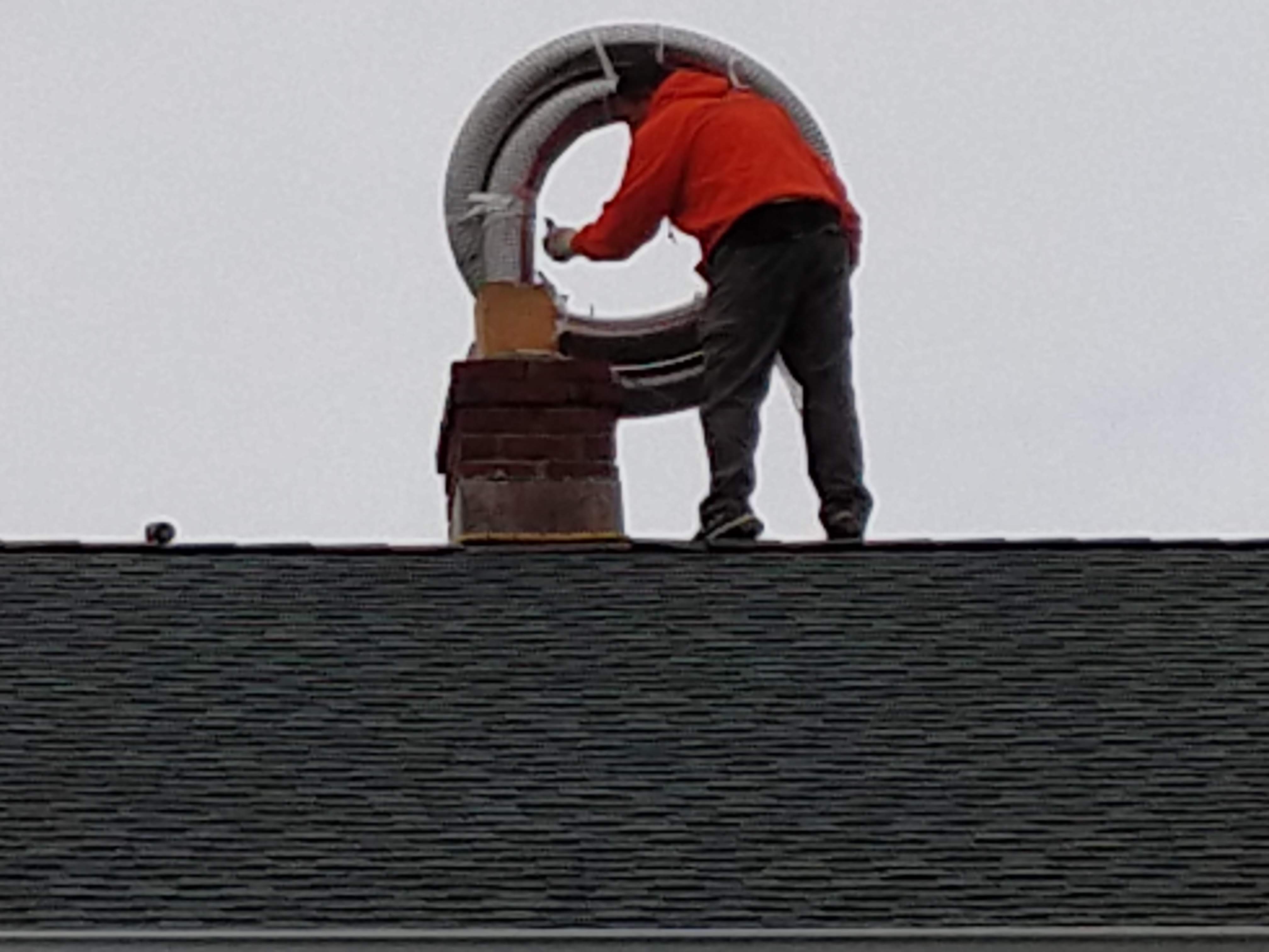 Flexible stainless chimney liner being installed in New Hyde Park, New York
